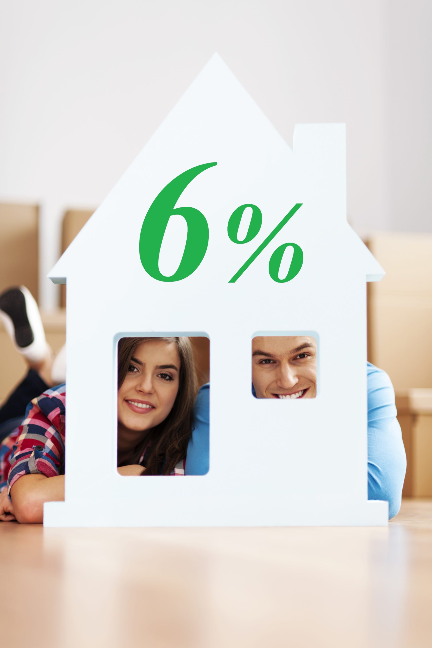 Happy couple with home sign